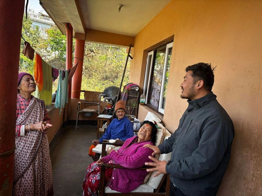 A volunteer caring for an elderly woman in Nepal