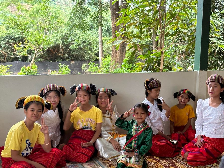 Girls in traditional dress at a village outreach visit