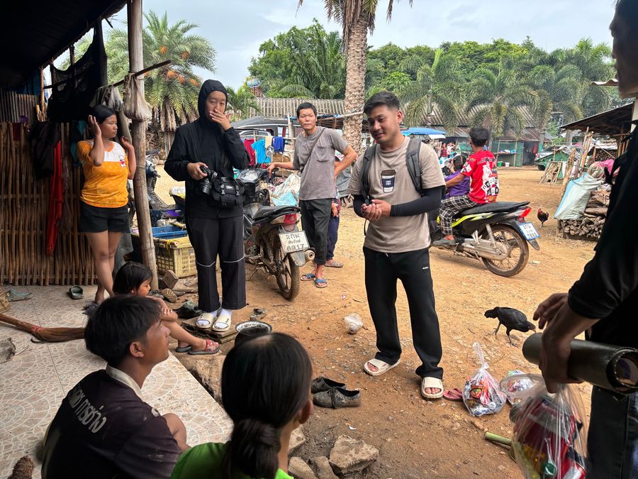 The outreach team talking with villagers during a home visit
