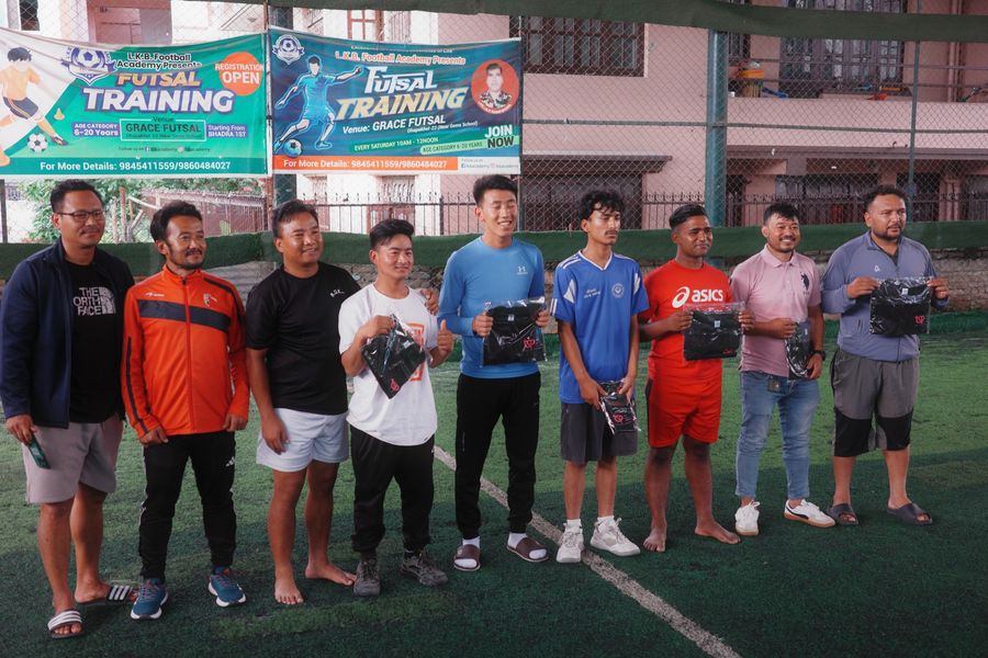 Coaches receiving team shirts at futsal training