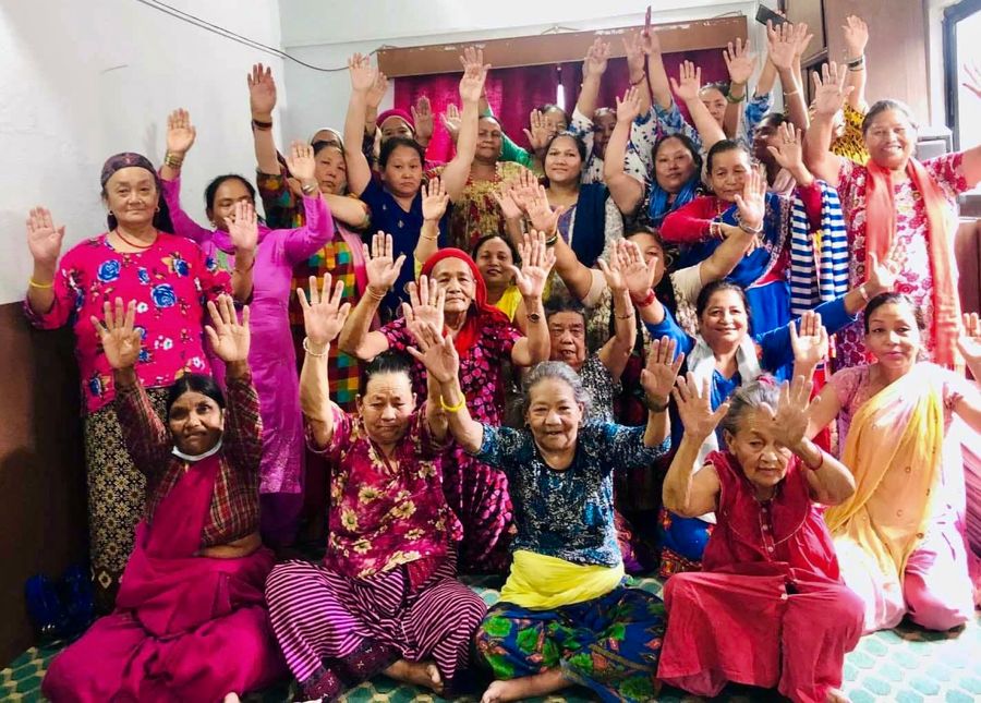 Women of the Women Ministry raising their hands together in worship